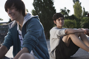Deutschland, Berlin, Jugendliche sitzen auf einem Spielplatz - WESTF015364