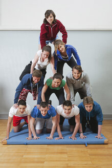 Germany, Berlin, Young people and teenager building human pyramid - BAEF000159