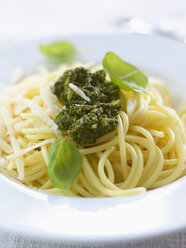 Spaghetti with pesto, parmesan and basil, close up - KSWF000640