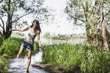 Germany, Cologne, Young woman standing in creek - JOF000106