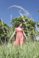 Germany, Cologne, Young woman looking down, smiling - JOF000108