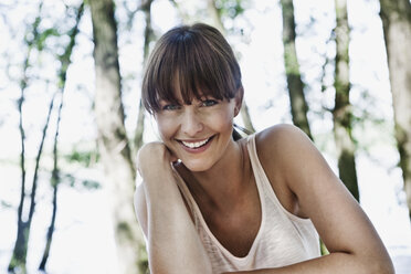 Germany, Cologne, Young woman smiling, portrait - JOF000160