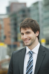 Germany, Hamburg, Businessman smiling, portrait - WESTF015478