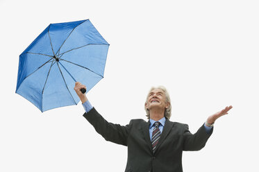 Germany, Hamburg, Businessman with umbrella - WESTF015487