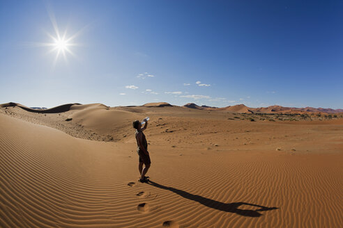 Afrika, Namibia, Namib-Wüste, Namib-Naukluft-Nationalpark, Älterer Mann trinkt Wasser aus Wasserflasche - FOF002402