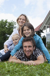 Germany, Munich, Family in front of house, smiling, portrait - RBF000402