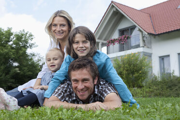 Germany, Munich, Family in front of house, smiling, portrait - RBF000403