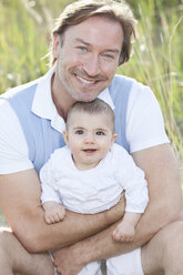 Deutschland, Bayern, Vater mit (2-5 Monate) Baby Mädchen, lächelnd - MAEF002543