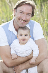 Germany, Bavaria, Father with (2-5 months) baby girl, smiling - MAEF002543