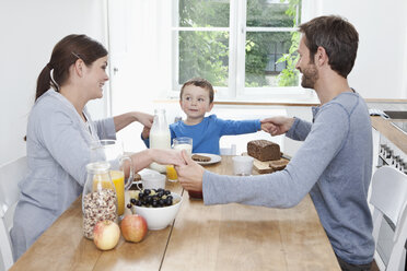 Germany, Bavaria, Munich, Family having breakfast together happily - RBF000382
