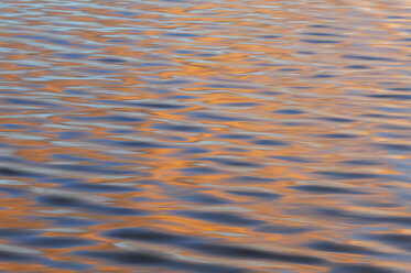 South America, Argentina, Tierra Del Fuego, Colourful reflections on ripples of water - RUEF000523