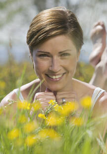 Germany, Munich, Mature woman lying in the grass stock photo