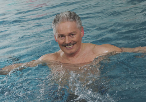 Deutschland, Nürnberg, Älterer Mann im Schwimmbad, Porträt, lächelnd - WBF000472