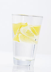 Glass of water with lemon slices on white background - WBF000252