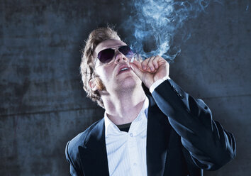 Young man smoking a cigarette - WBF000737