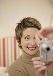 Ältere Frau fotografiert sich selbst mit Digitalkamera - WBF000806