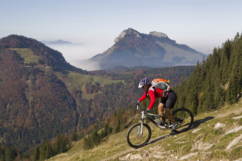 Austria, Tirol, Female mountain biker biking on spitzstein mountain - FFF001132