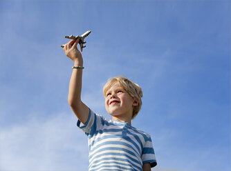 Germany, Bavaria, Boy (4-5 Years) playing with toy airplane - HSIF000011