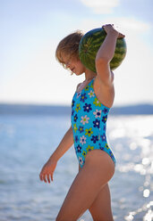 Croatia, Zadar, Girl carrying watermelon at beach - HSIF000028