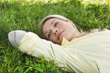 Germany, Cologne, Woman lying on grass - WESTF015660