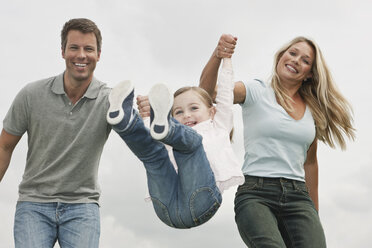 Germany, Cologne, Parents swings her daughter (2-3 Years), smiling - WESTF015676