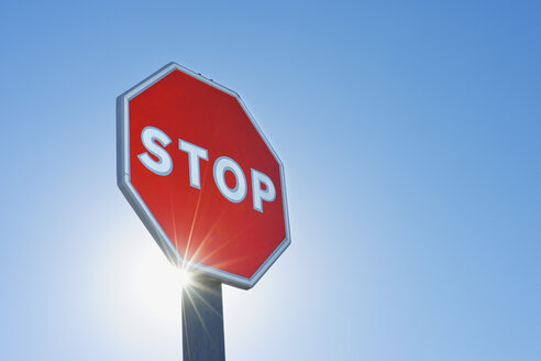 Spain, Province of Ciudad Real, Castile-La Mancha, Stop sign against clear blue sky - RUEF000608