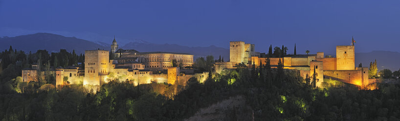 Spain, Andalusia, Granada Province, View of Alhambra Palace illuminated at dusk - RUEF000616