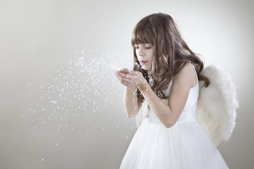 Girl (10-11 Years) blowing glitter - MAEF002645