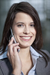 Germany, Bavaria, Business woman on the phone, smiling, portrait - MAEF002701