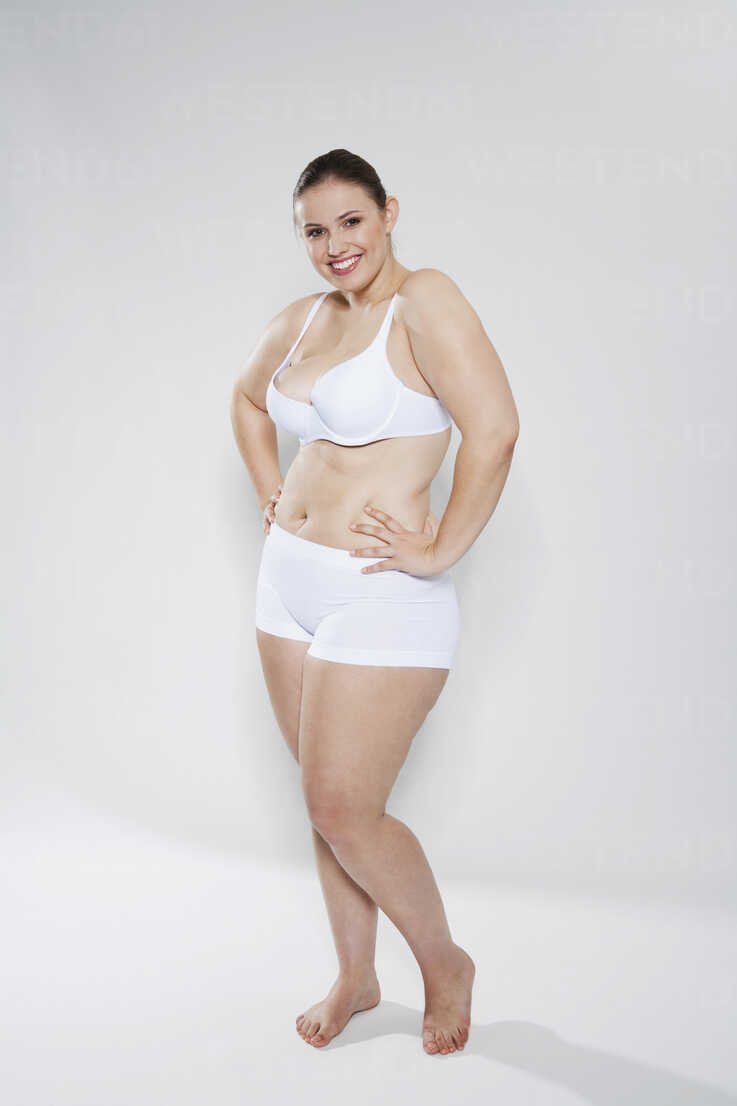 Fat Smiling Woman In White Underwear Holding Free Stock Photo and