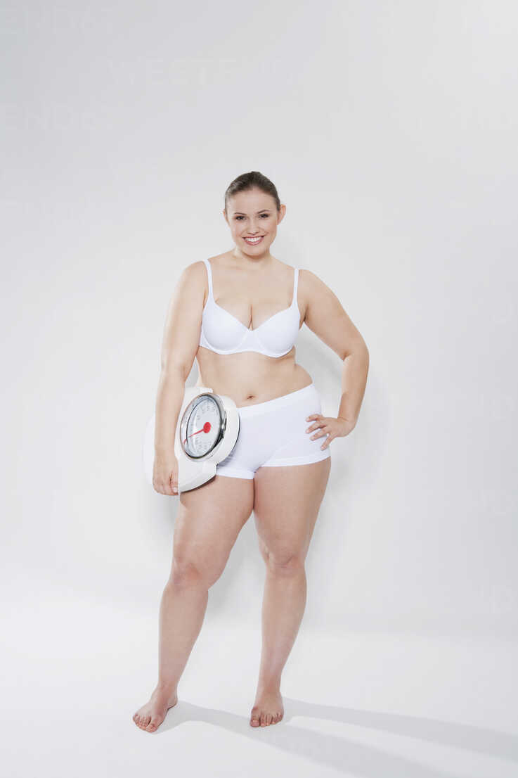 Fat Smiling Woman In White Underwear Holding Free Stock Photo and