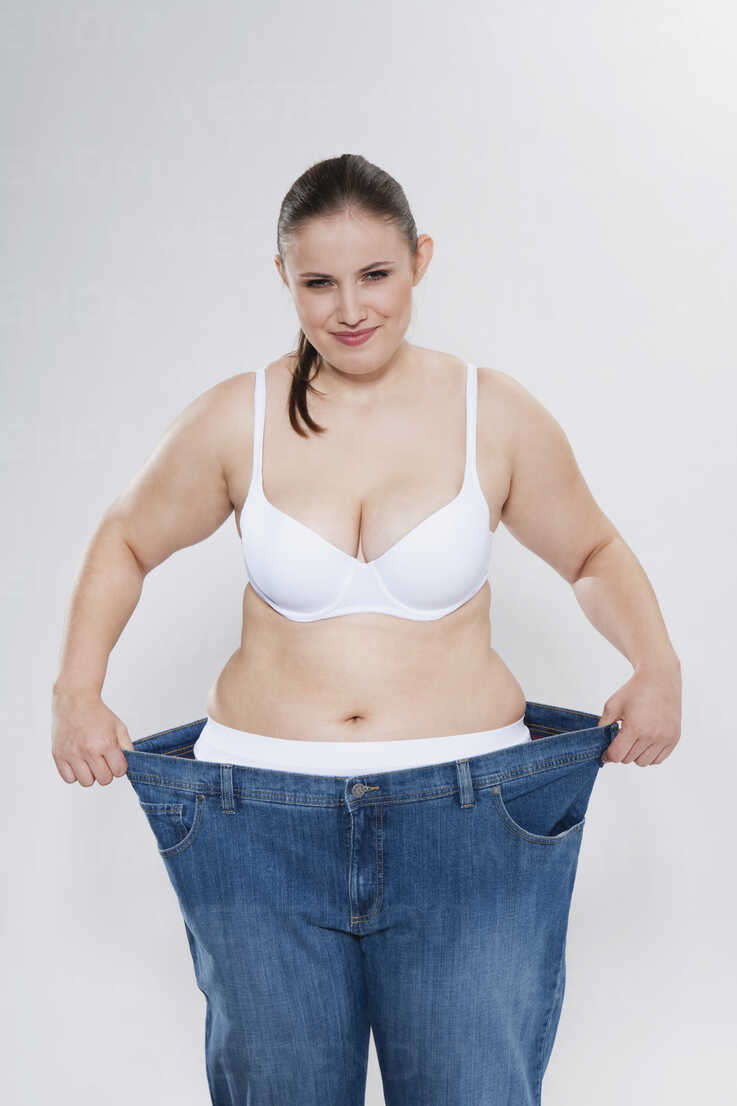 Young chubby woman with oversized pant, portrait stock photo