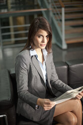 Germany, Bavaria, Businesswoman sitting with document - MAEF002758