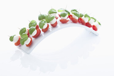 Mozarella with Basil in tooth picks on white background - MAEF002883