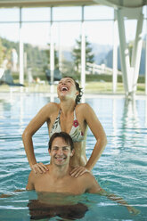 Italy, SouthTyrol, Couple in swimming pool of hotel urthaler - WESTF015864