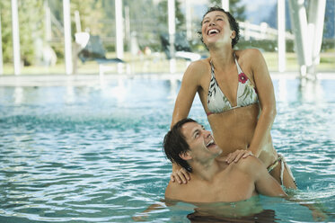 Italy, SouthTyrol, Couple in swimming pool of hotel urthaler - WESTF015863