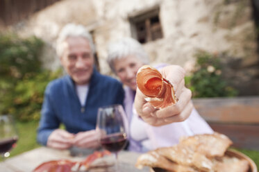 Italien, Südtirol, Älteres Paar bei der Brotzeit auf einer Berghütte - WESTF016013