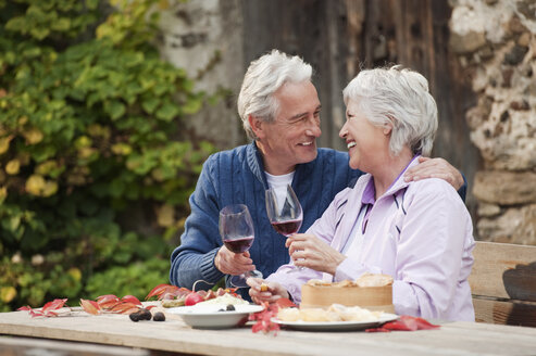 Italy, South Tyrol, Mature couple having their snacks at mountain hut - WESTF016017