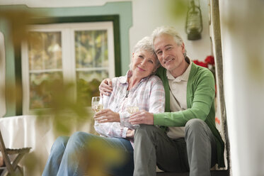 Italy, South Tyrol, Mature couple with wine glass at guesthouse - WESTF016034