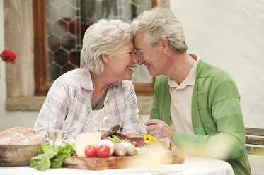 Italy, South Tyrol, Mature couple having their snacks at guesthouse - WESTF016036