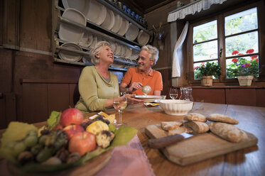 Italy, South Tyrol, Mature couple having their snacks at guesthouse - WESTF016055