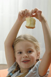 Germany, Bavaria, Girl holding apple, portrait - CRF002021