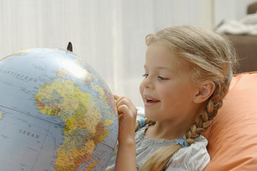 Germany, Bavaria, Girl looking at globe, close up - CRF002022