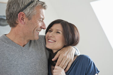 Germany, Munich, Mature man embracing woman, smiling - NHF001266