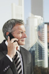 Germany, Frankfurt, Businessman on the phone in office - SKF000485