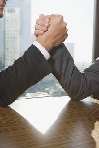 Germany, Frankfurt, Businessmen doing arm wrestling stock photo