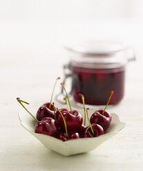 Cherries with jam jar in background - KSWF000645