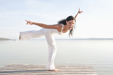 Mid adult woman standing on jetty, portrait - UMF000326