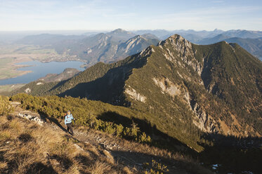 Germany, Bavaria, Senior woman at heimgarten and herzogstand mountain ranges - MIRF000085