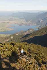 Germany, Bavaria, Senior woman at heimgarten and herzogstand mountain ranges - MIRF000086